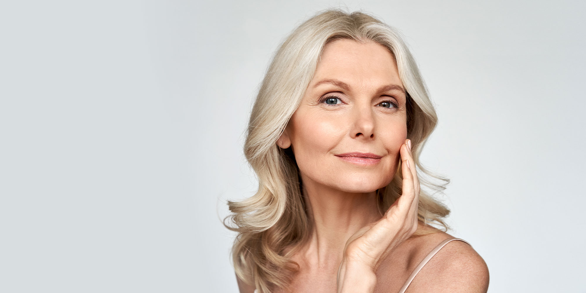 woman looking at her smooth skin after botox