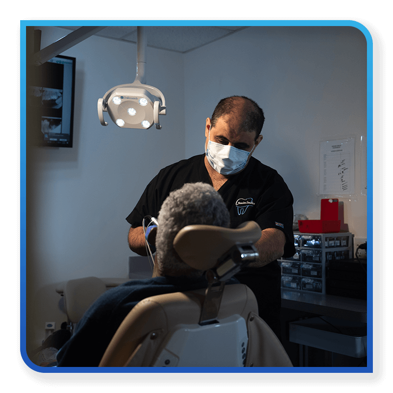 Mina Elfar, DMD in middle of dental procedure on patient