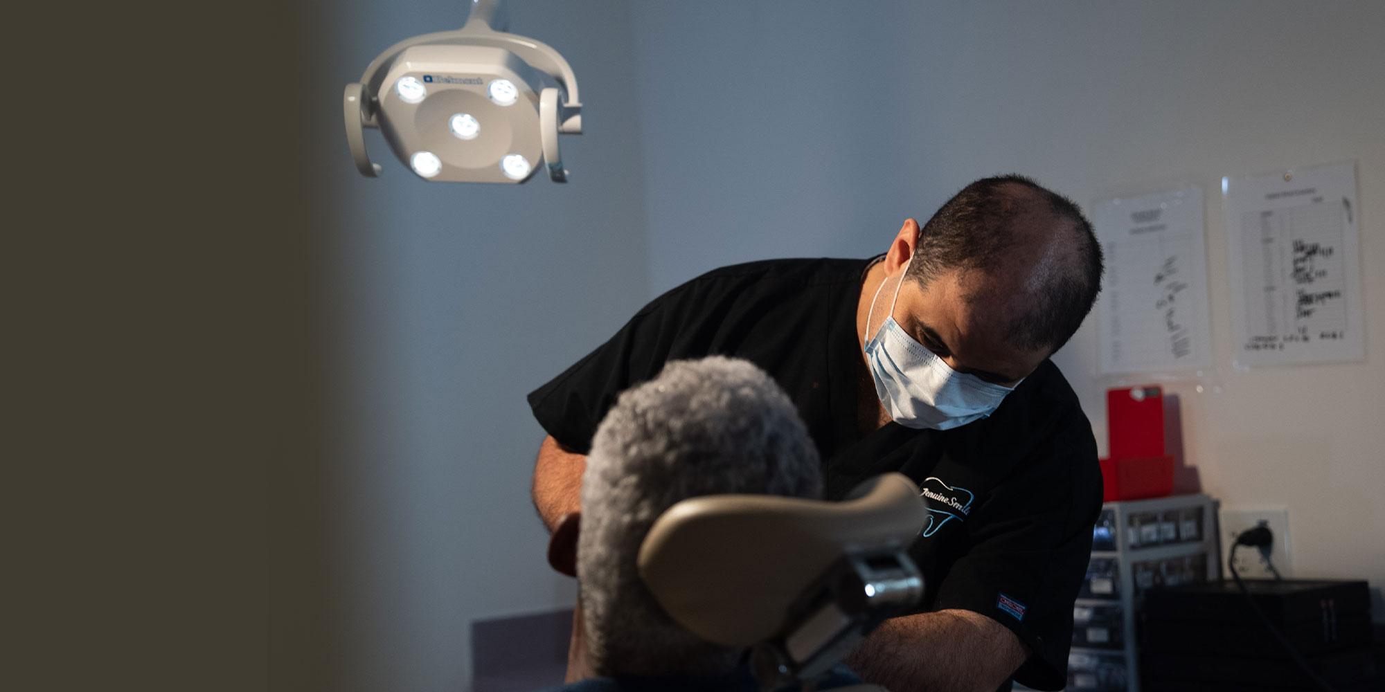 Mina Elfar, DMD in the process of oral surgery with patient